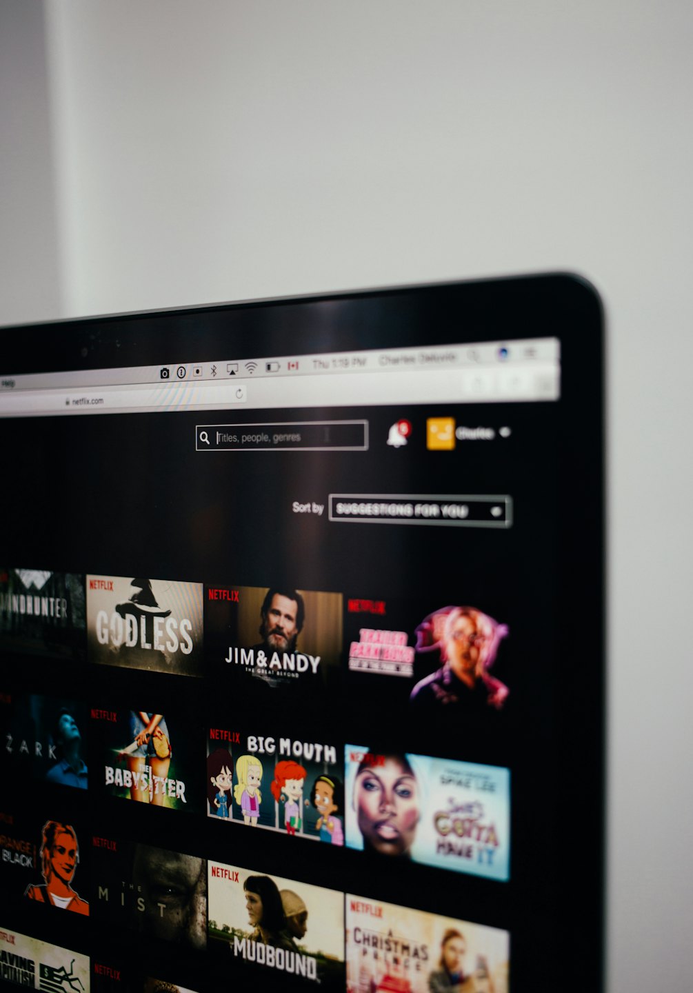 Laptop screen shows the Netflix streaming interface.
